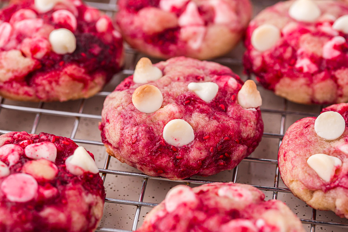 close up angled shot of raspberry cookies on cooling rack