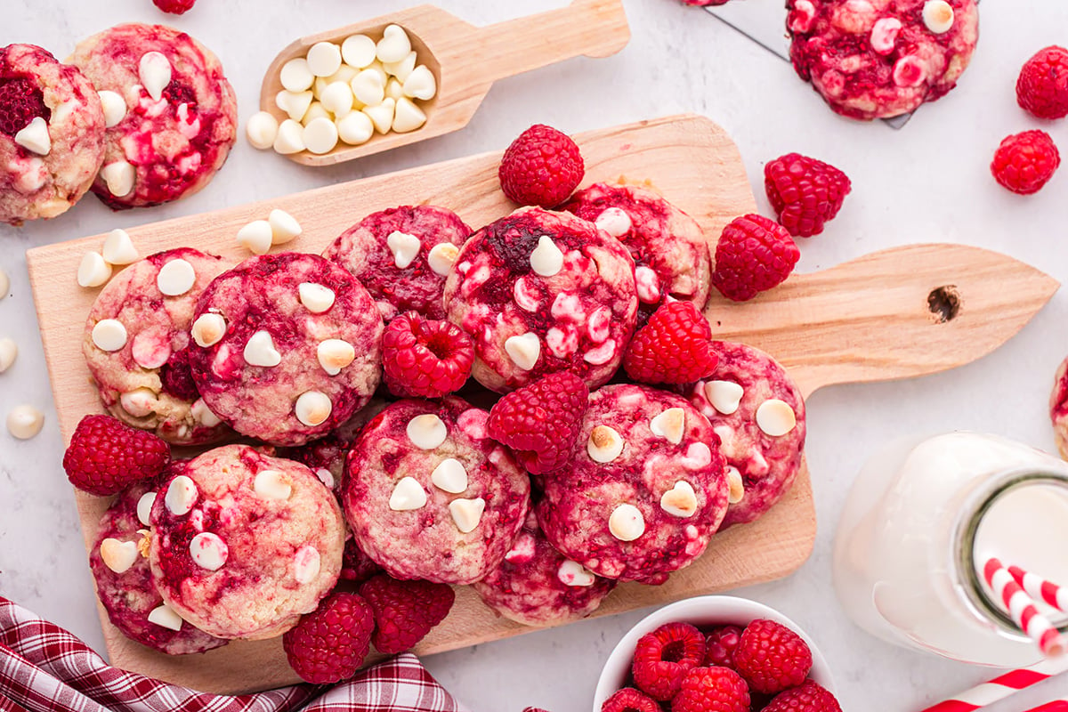 overhead shot of raspberry cookies on wooden board