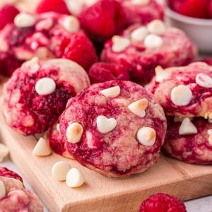 angled shot of raspberry cookies on wooden board