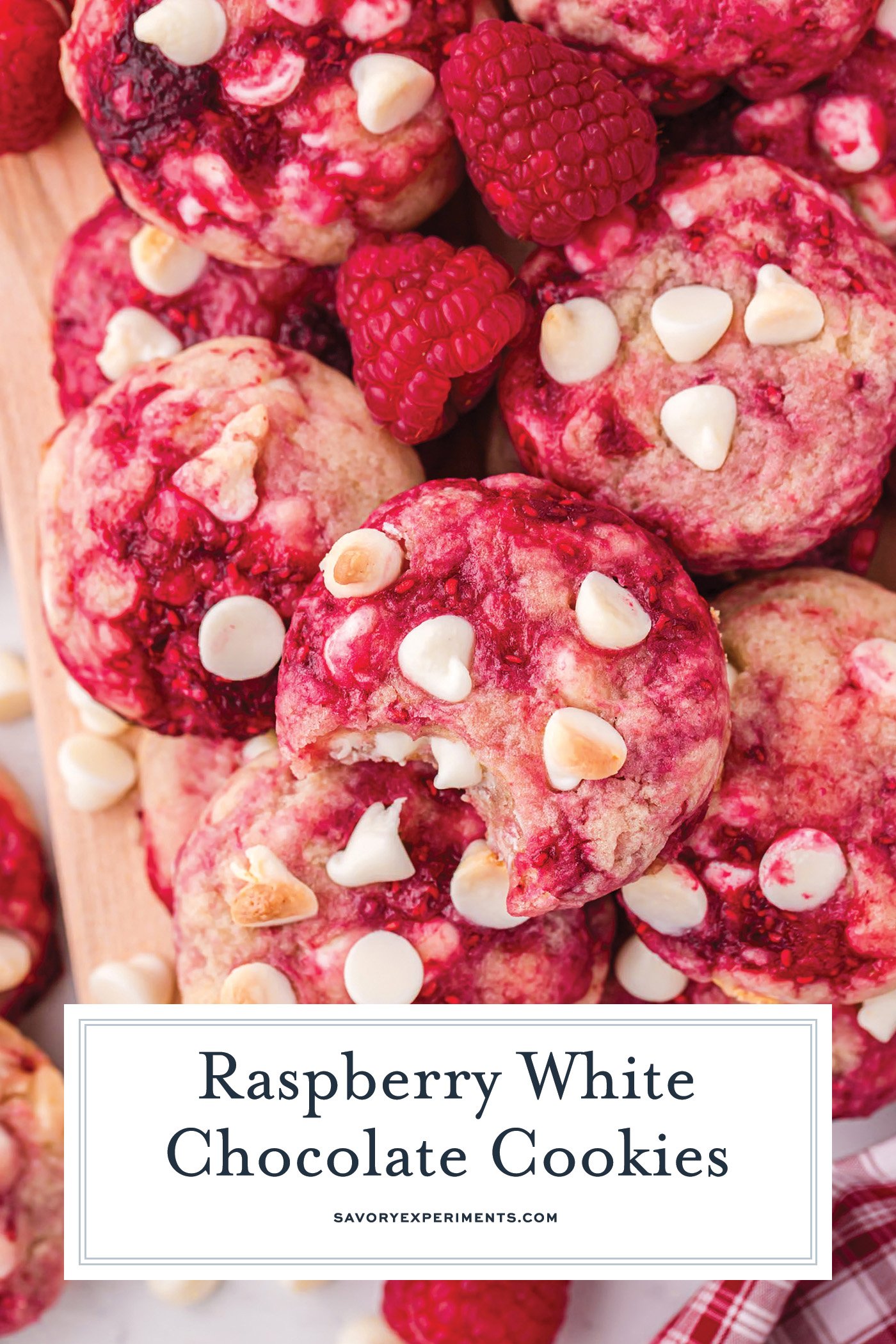 overhead shot of raspberry cookies on a wooden board with text overlay for pinterest