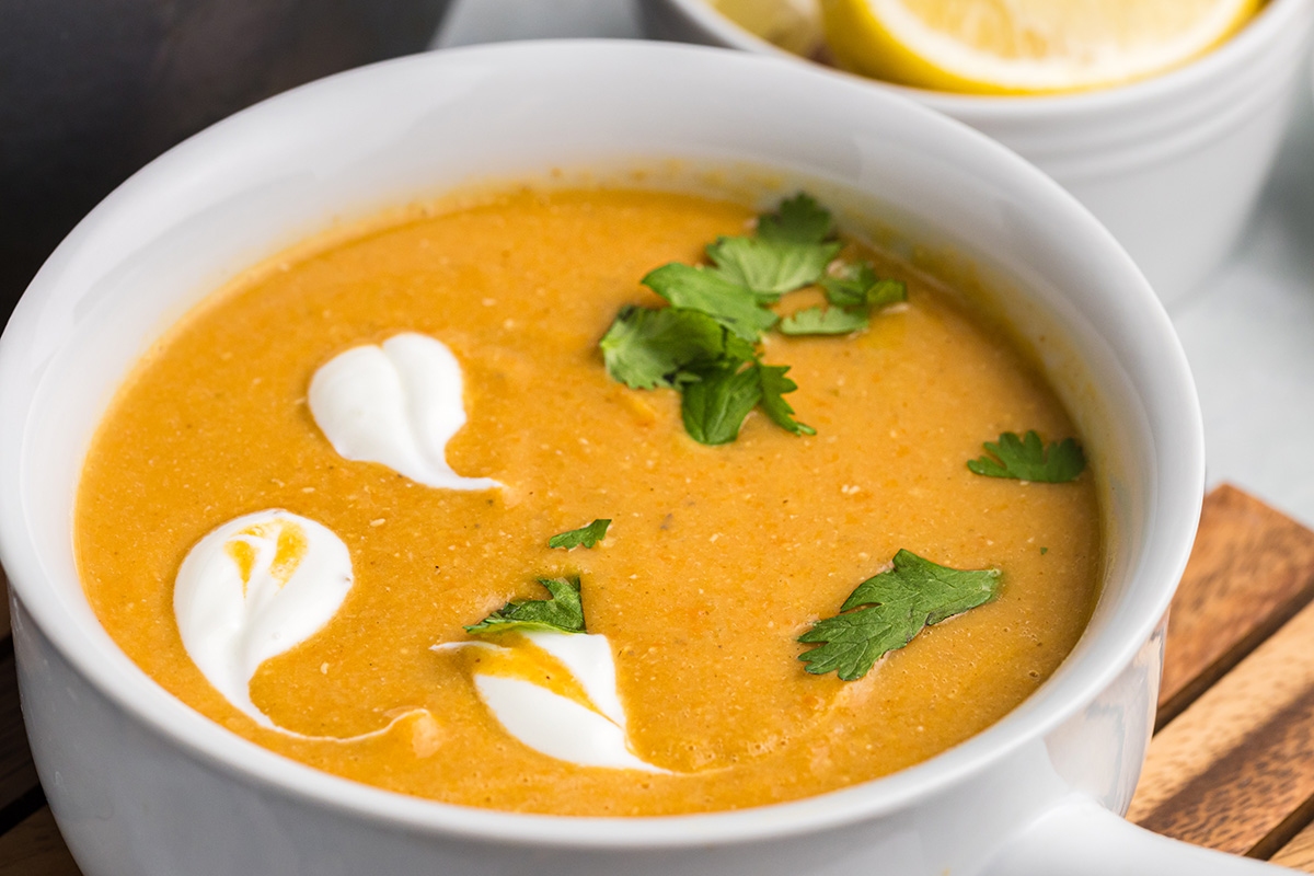 close up angled shot of bowl of red lentil soup