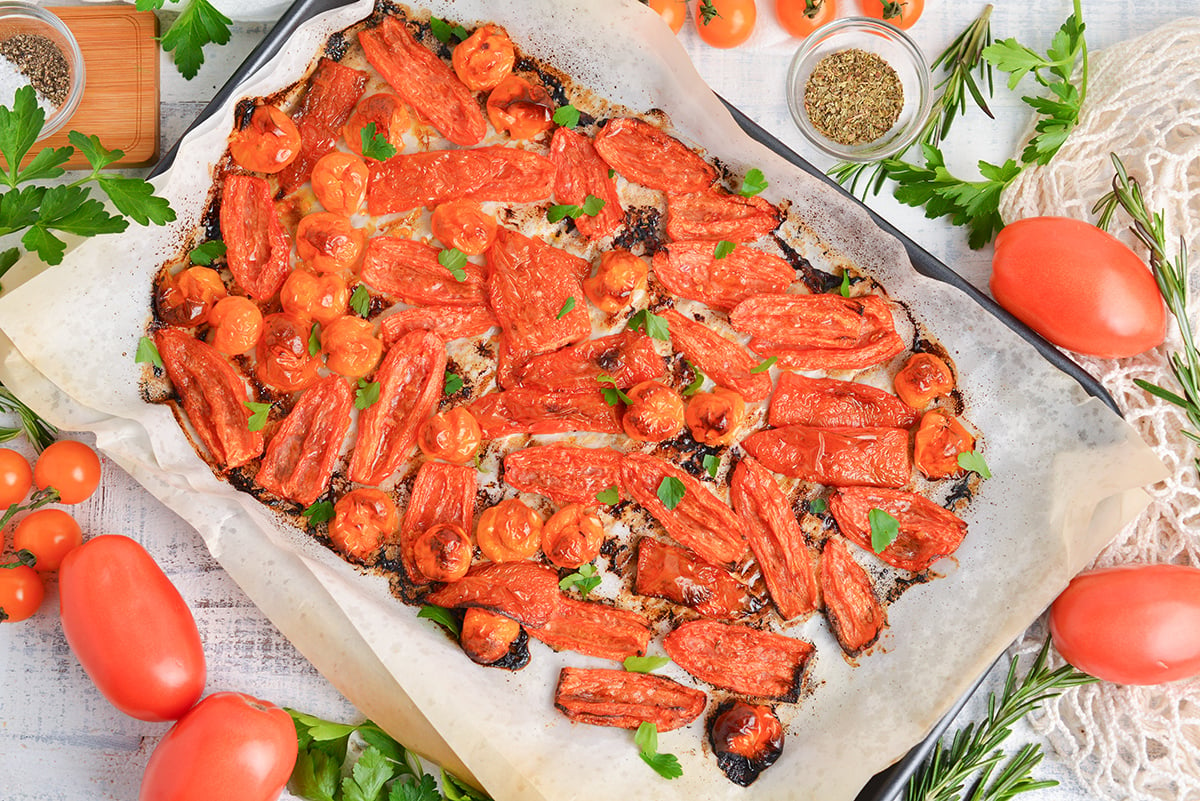 overhead shot of oven roasted tomatoes on sheet pan