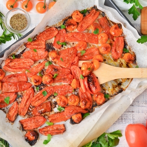 overhead shot of oven roasted tomatoes on sheet pan