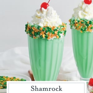 straight on shot of two shamrock shakes with text overlay for pinterest