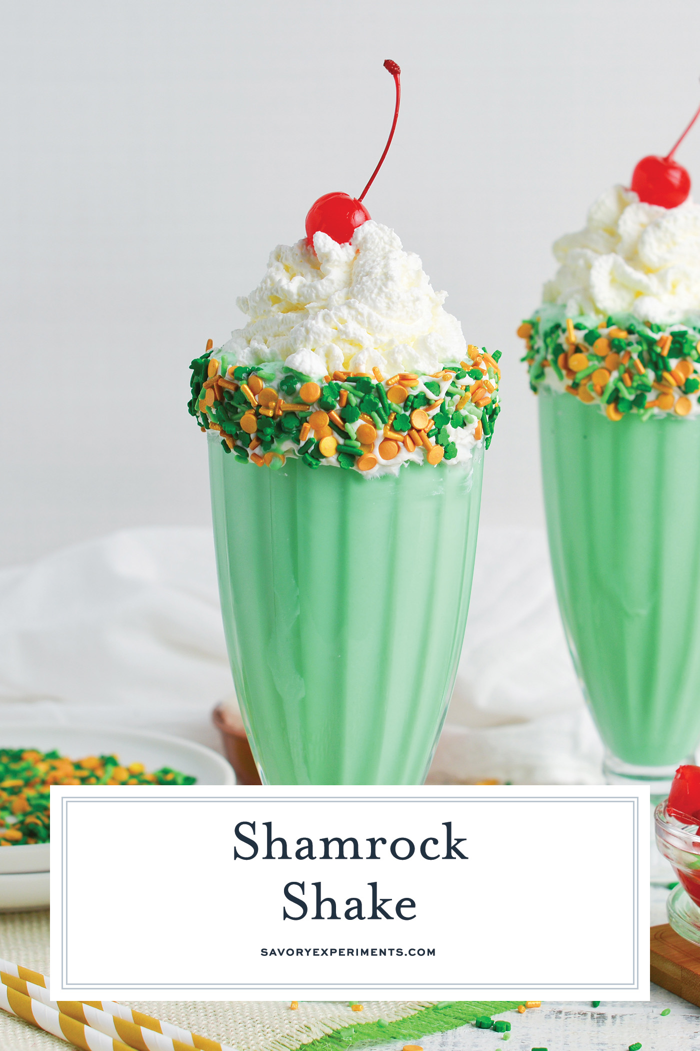 straight on shot of two shamrock shakes with text overlay for pinterest