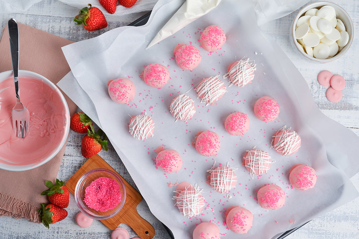 overhead shot of strawberry cheesecake bites on sheet pan