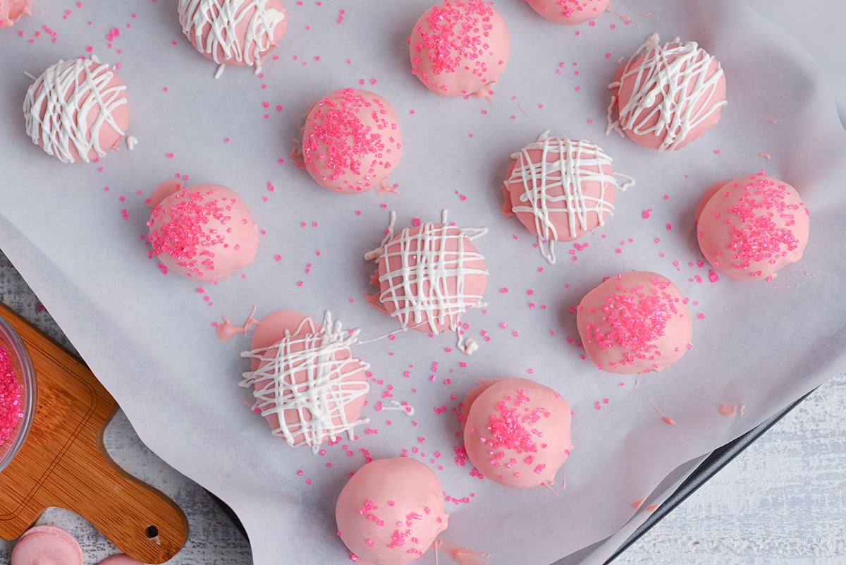 close up overhead shot of strawberry cheesecake bites on sheet pan