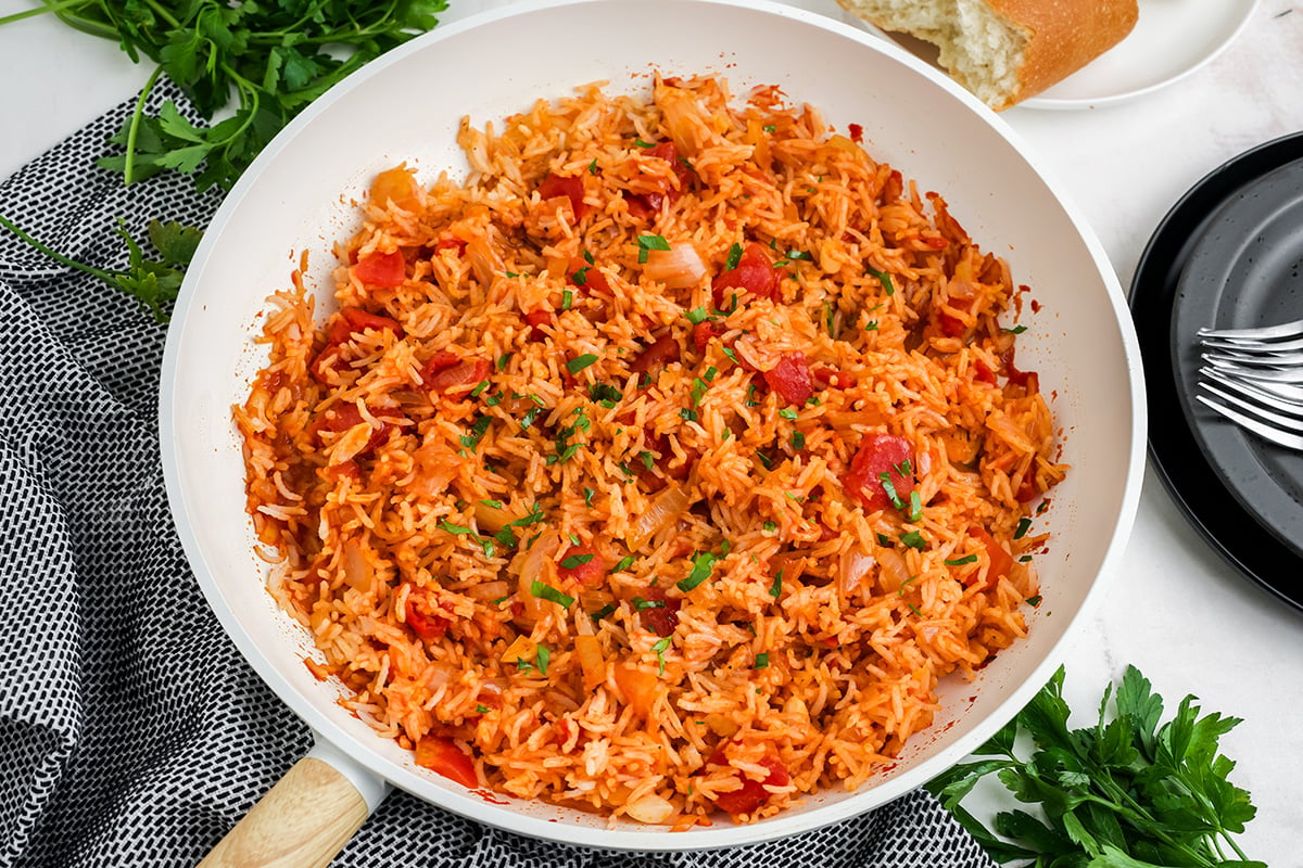 angled shot of tomato rice in pan