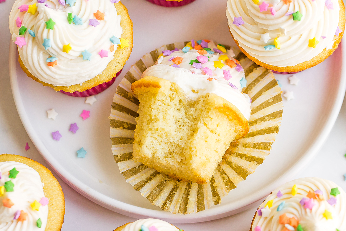 bite taken out of a vanilla cupcakes