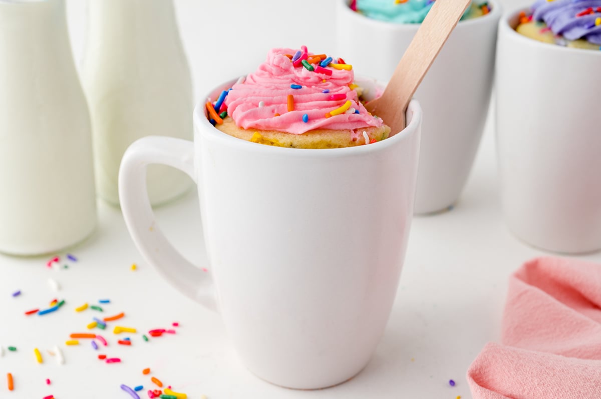 head-on view of a white mug filled with single serving cake