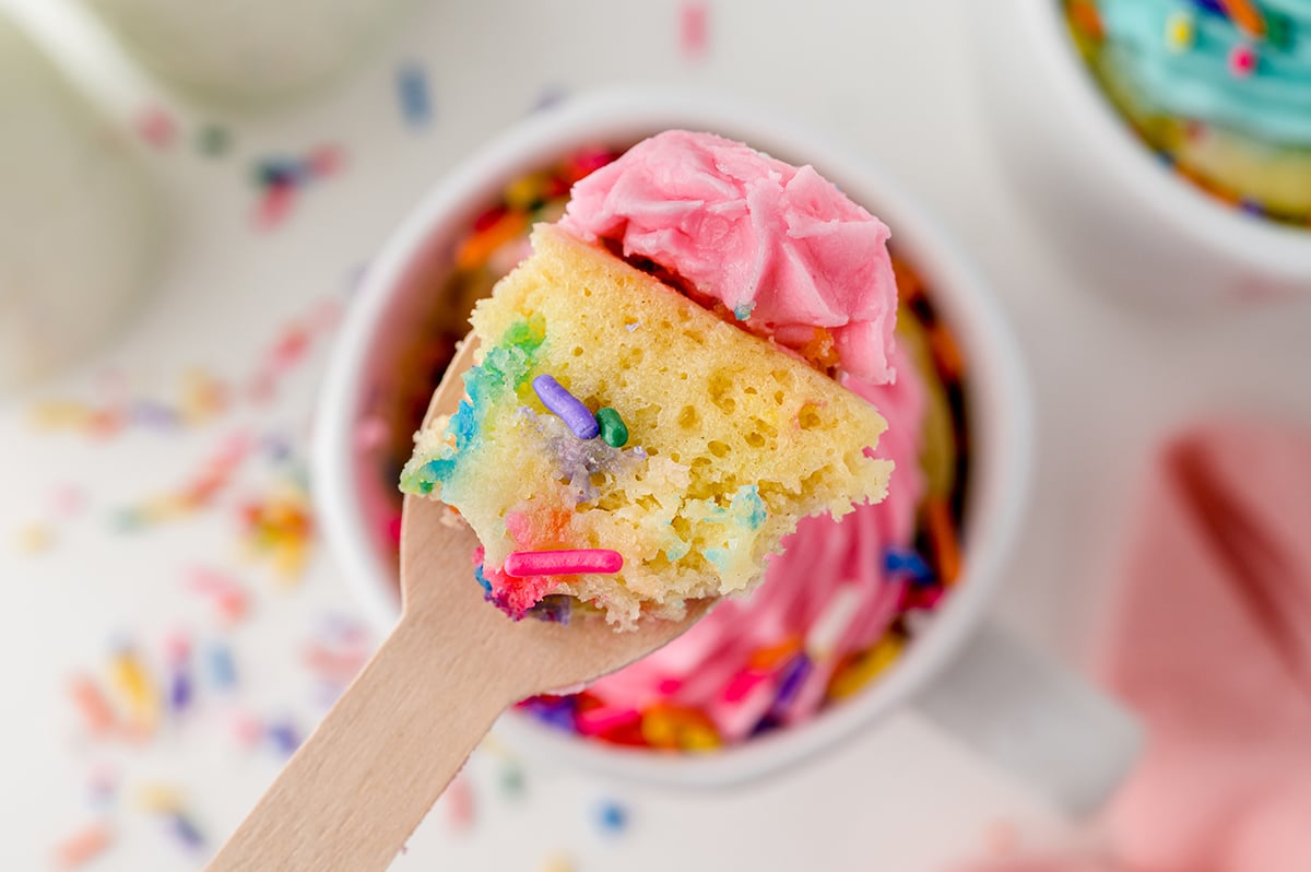 close up bite shot of vanilla cake with frosting