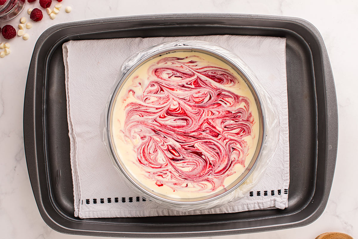 raspberry cheesecake batter swirled in pan