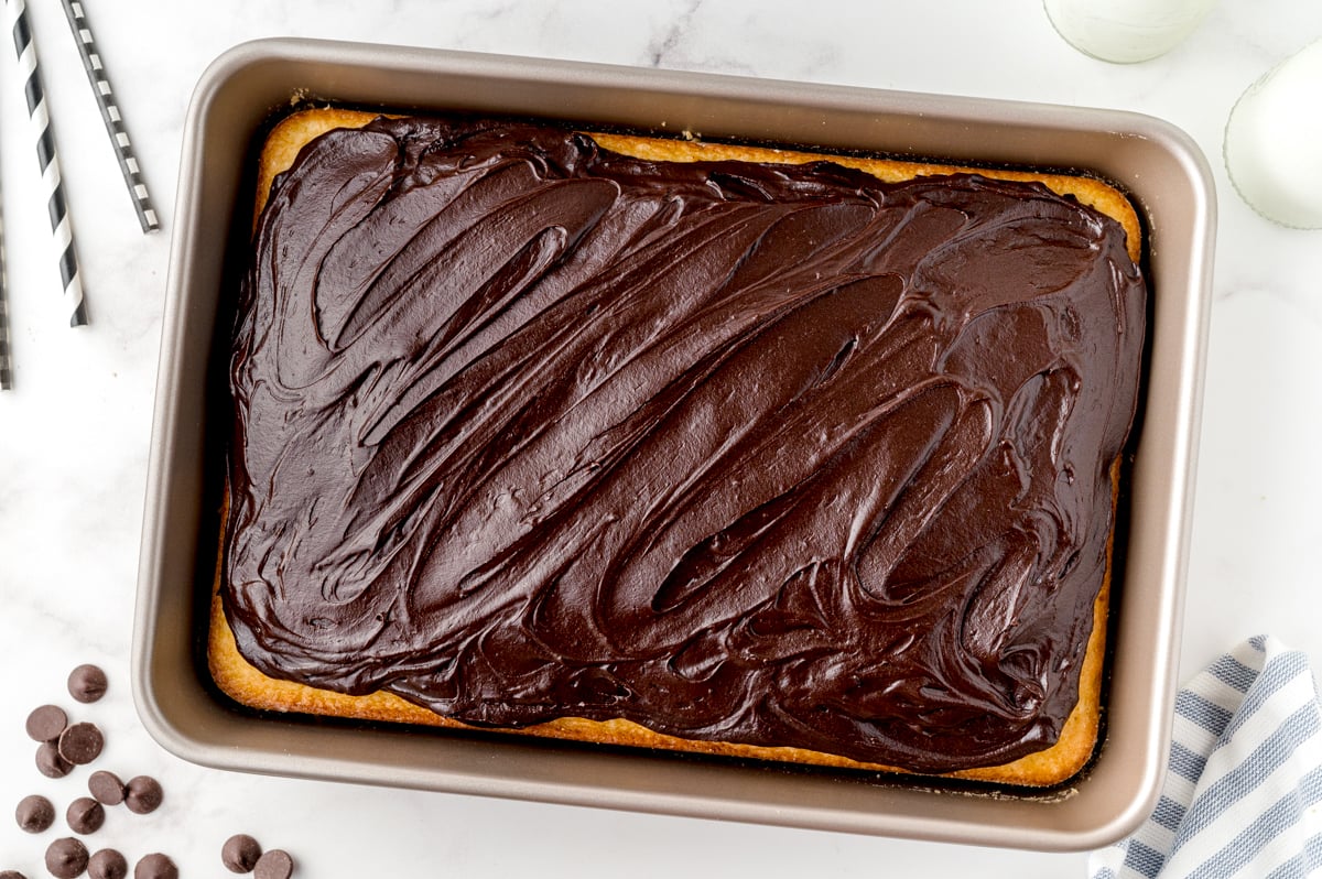 overhead shot of yellow sheet cake topped with chocolate frosting