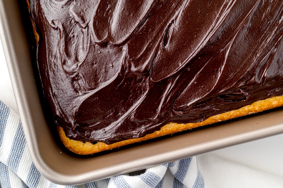 overhead corner image of yellow cake with chocolate icing