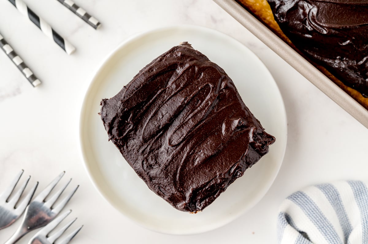 overhead square slice of cake with chocolate fudge frosting