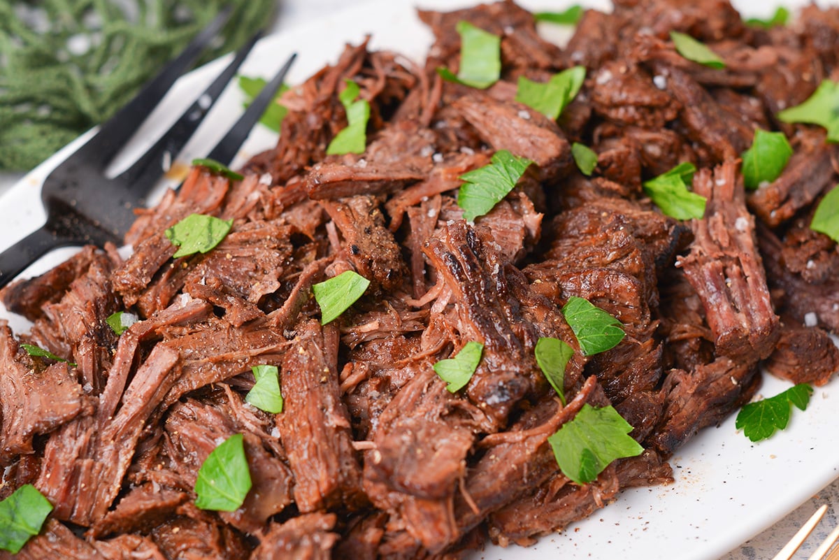 angled close up shot of shredded balsamic slow cooker pot roast