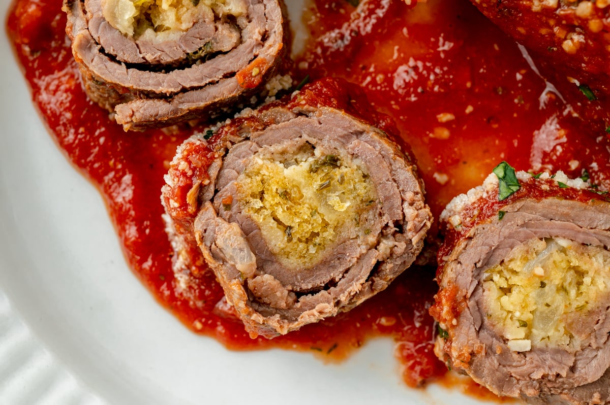 close up overhead shot of sliced beef braciole on plate