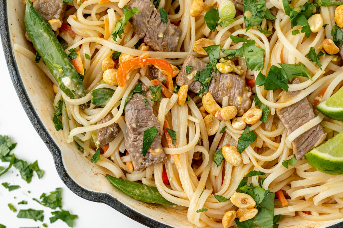 close up overhead shot of beef pad thai in pan