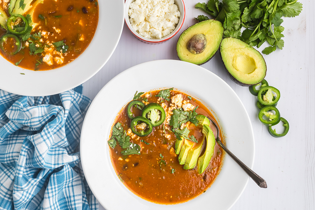 overhead shot of spoon in bowl of black bean soup