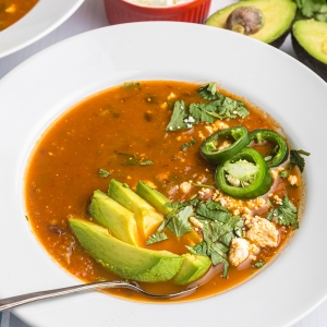 angled shot of spoon in bowl of black bean soup