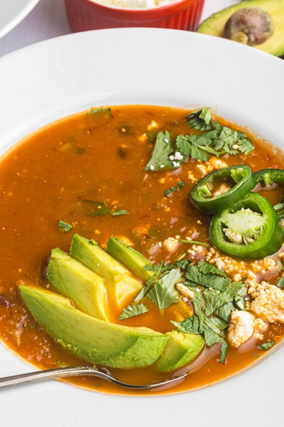 angled shot of spoon in bowl of black bean soup