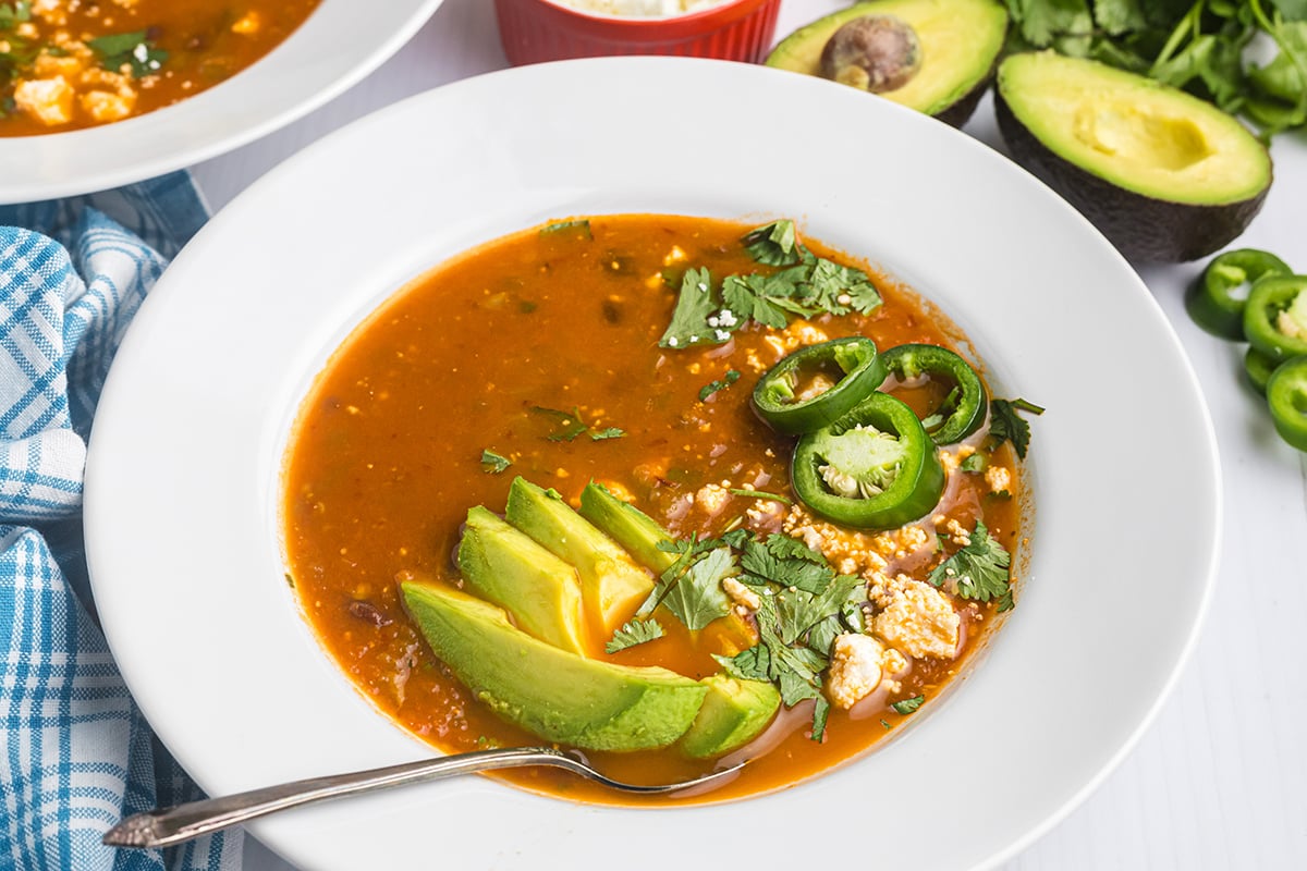 angled shot of spoon in bowl of black bean soup