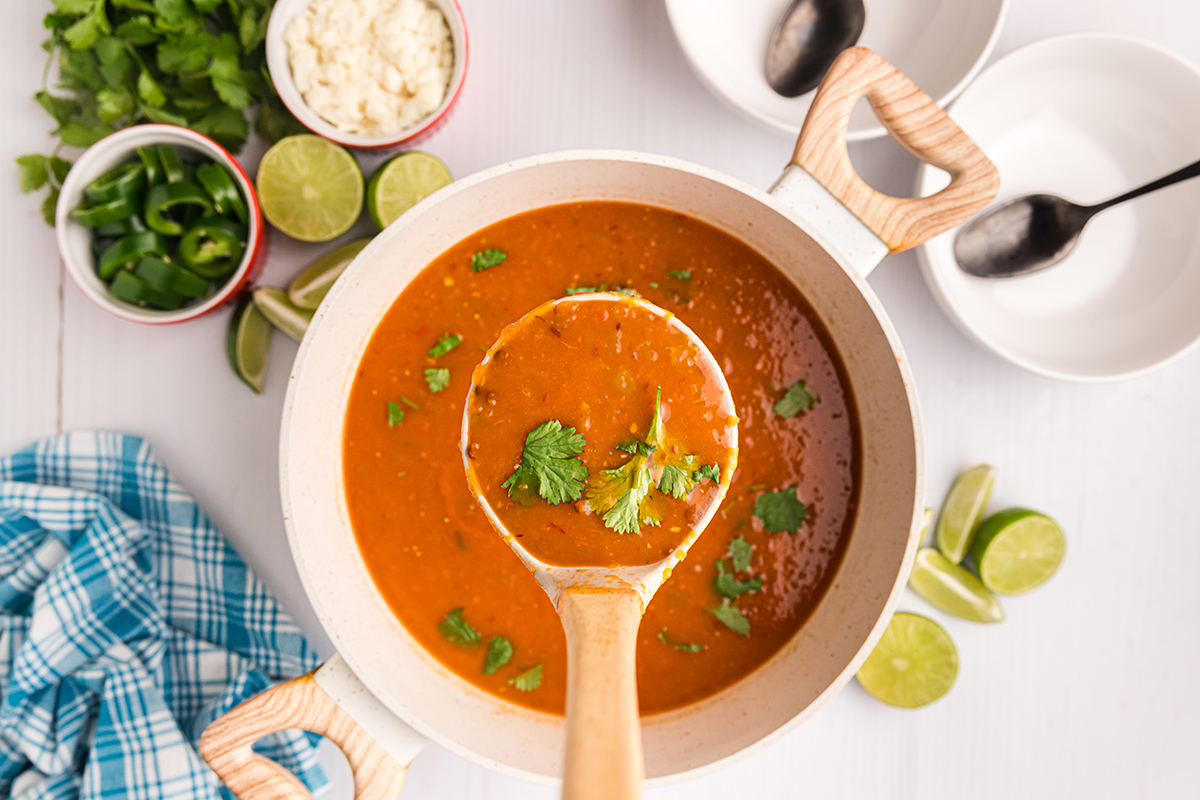 overhead shot of ladle full of black bean soup