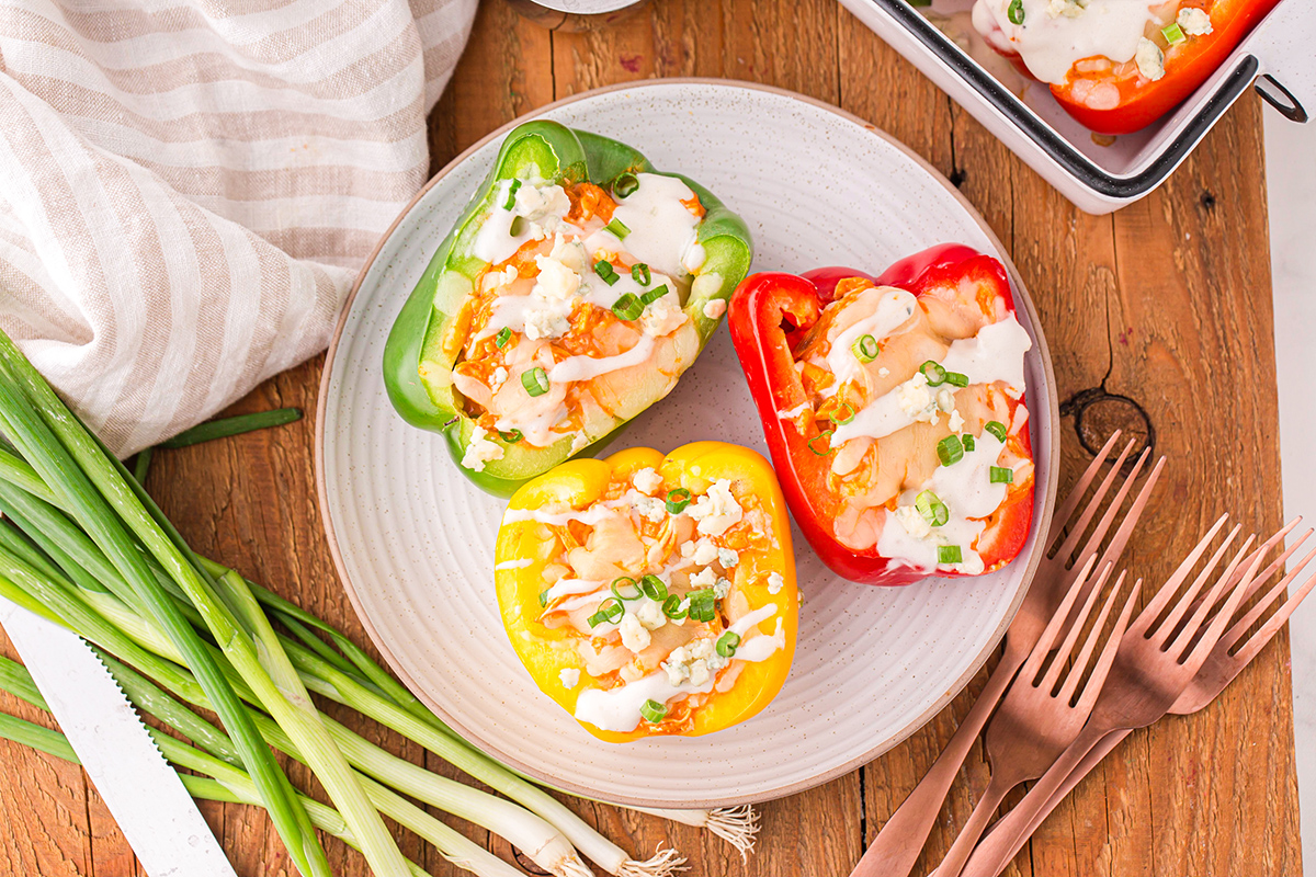 overhead shot of three buffalo chicken stuffed peppers on plate