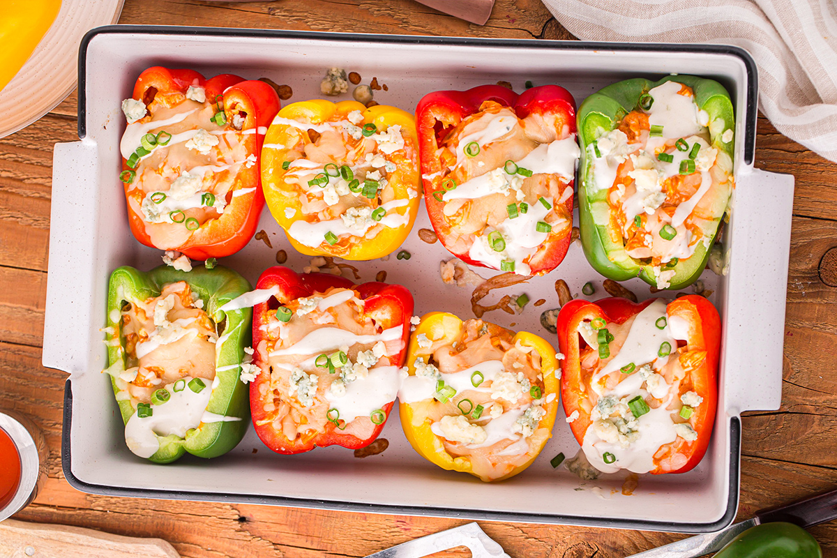 overhead shot of buffalo chicken stuffed peppers in baking dish