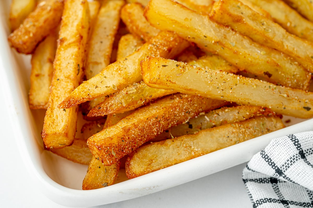 close up angled shot of cajun fries on sheet pan