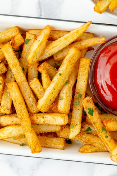 overhead shot of tray of Cajun fries with ketchup