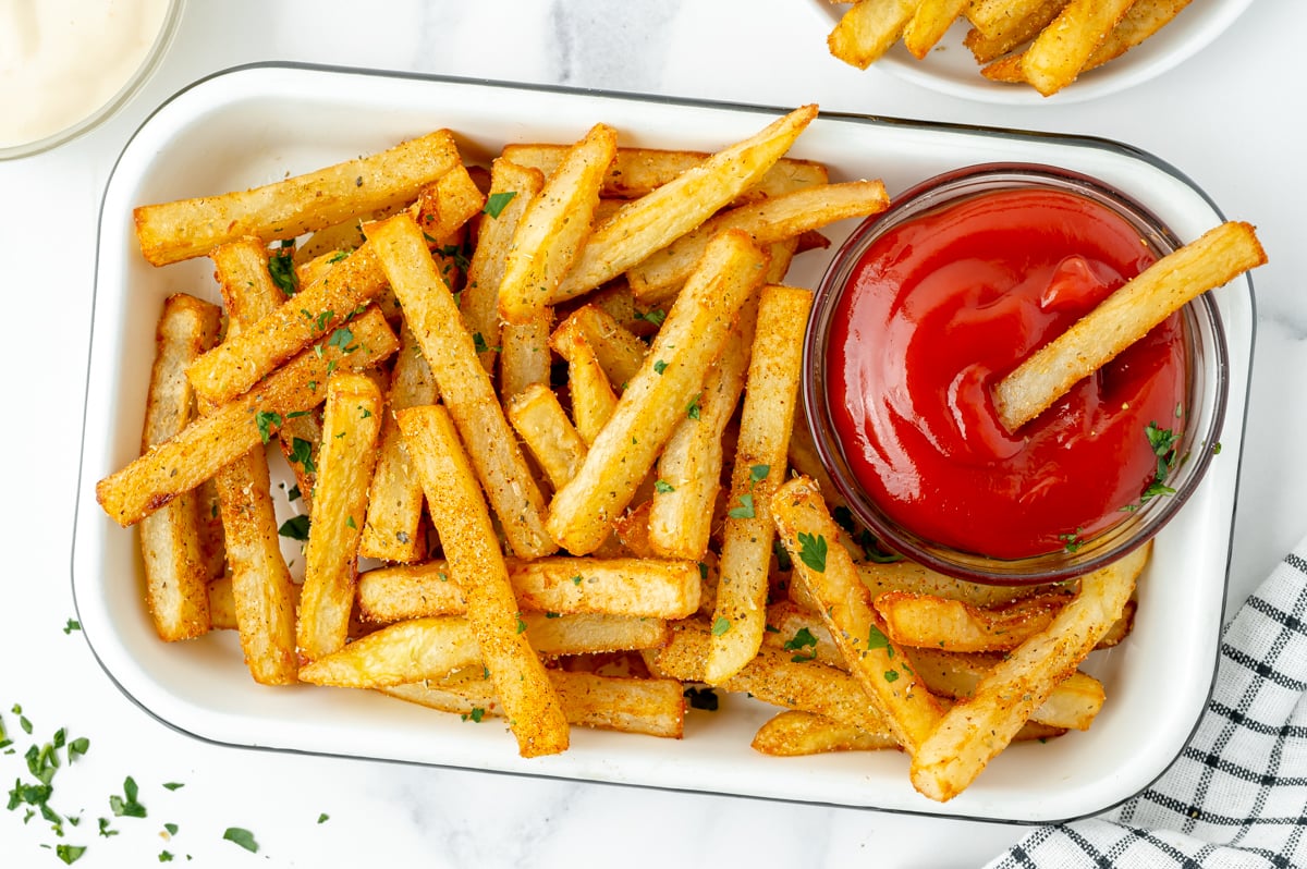 overhead shot of tray of Cajun fries with ketchup