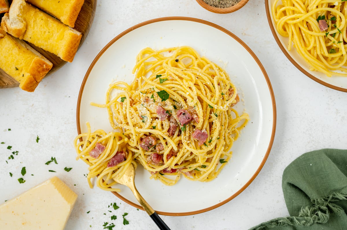 overhead shot of carbonara and fork on plate