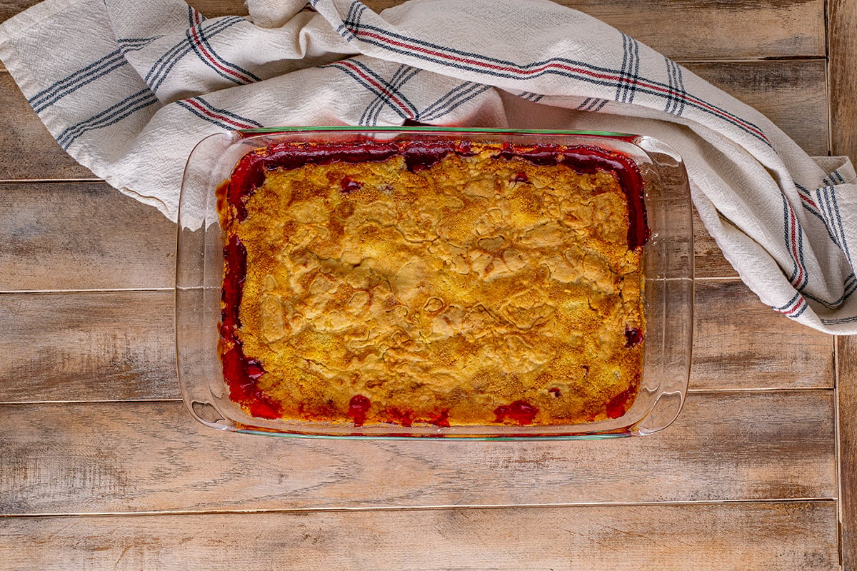 overhead of baked cherry dump cake in a glass baking dish