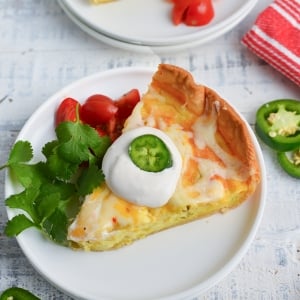 angled shot of slice of chile relleno quiche on plate