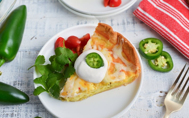 angled shot of slice of chile relleno quiche on plate