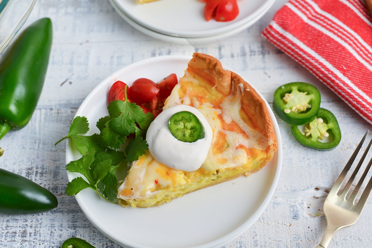 angled shot of slice of chile relleno quiche on plate