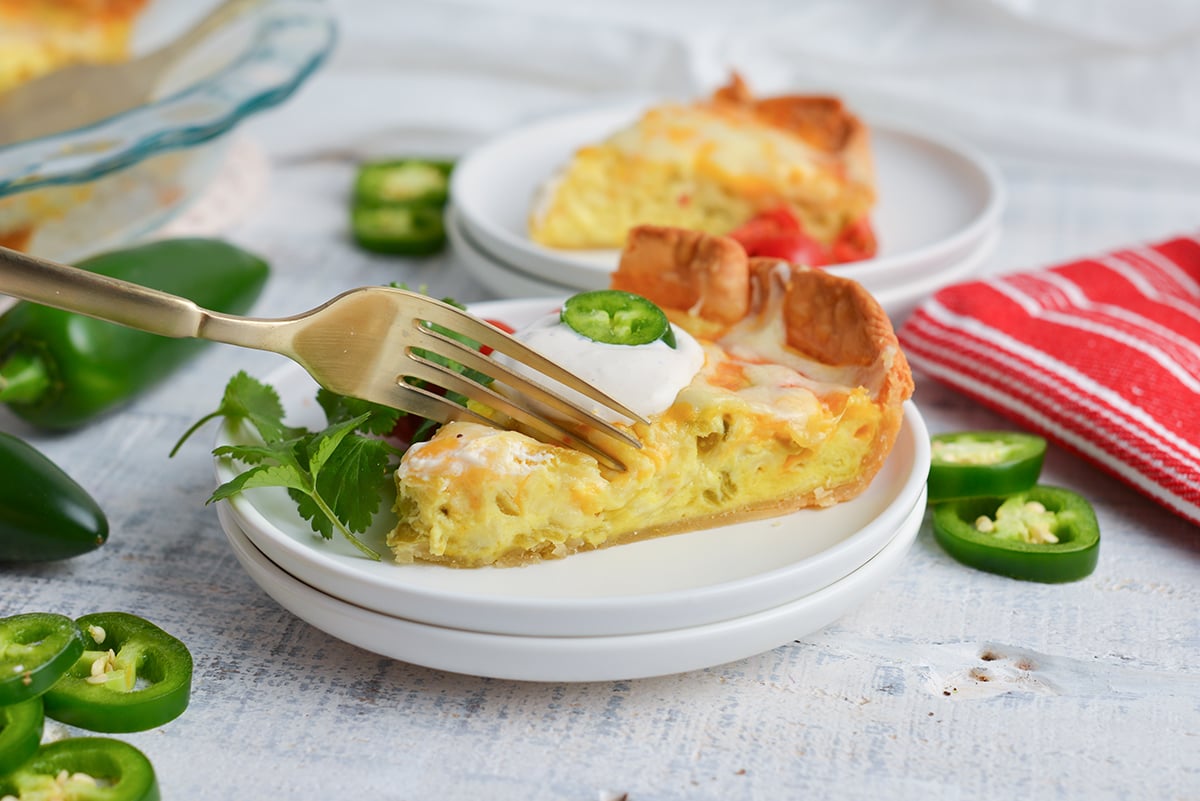 fork cutting into slice of chile relleno quiche