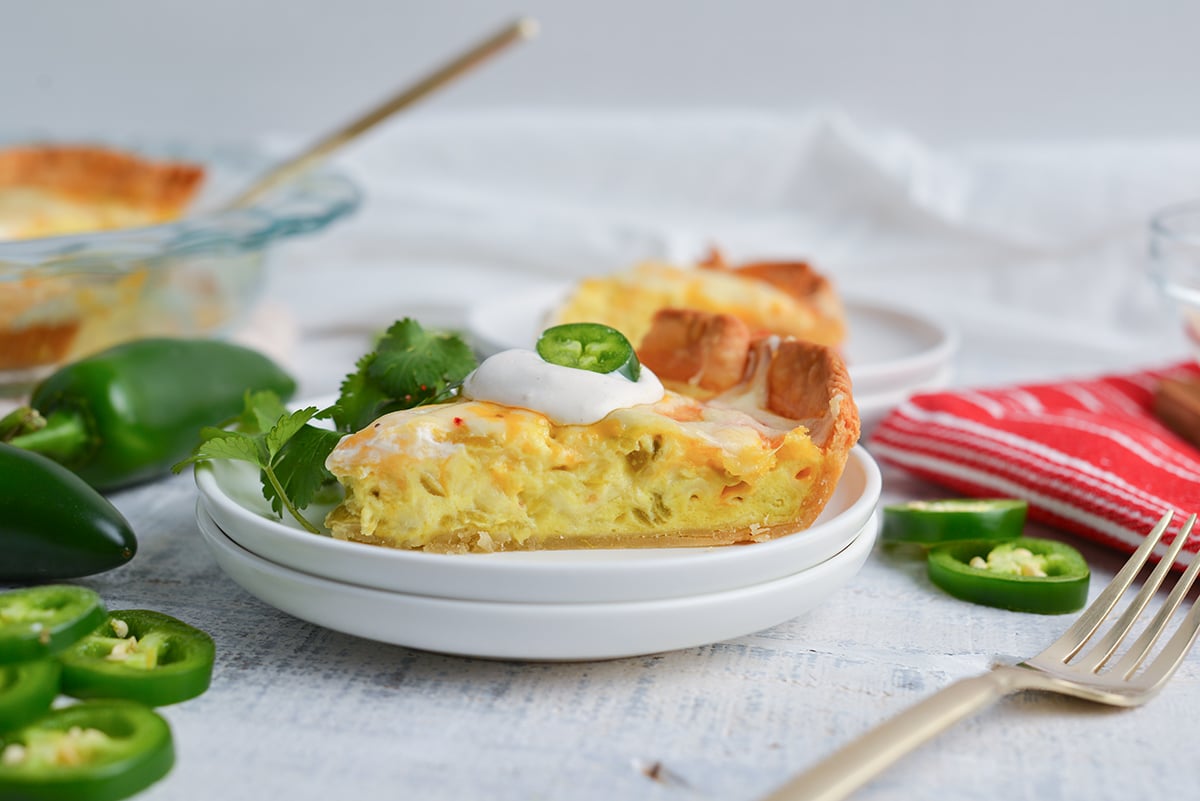 straight on shot of slice of chile relleno quiche on plate