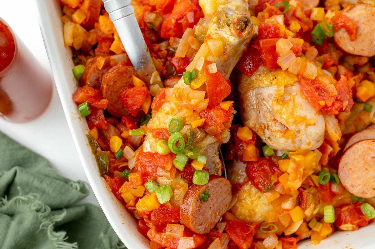 close up overhead shot of serving spoon in dish of creole chicken