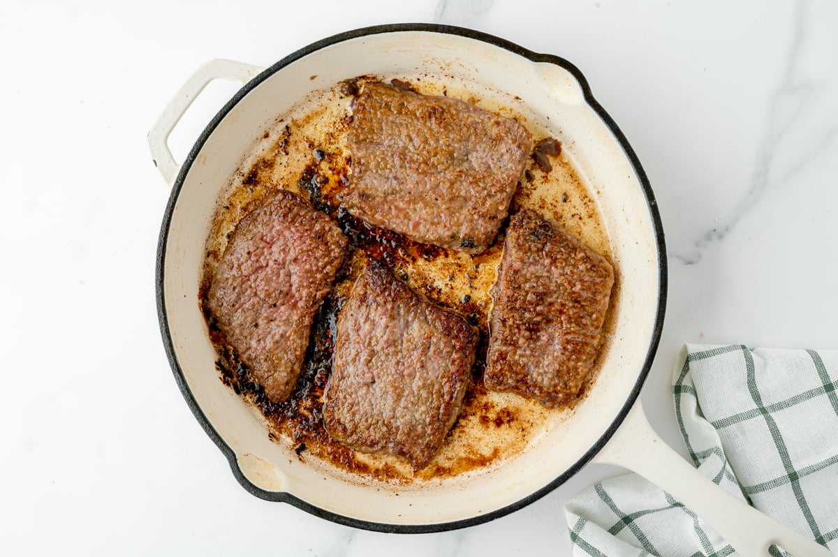 overhead shot of beef cooking in pan