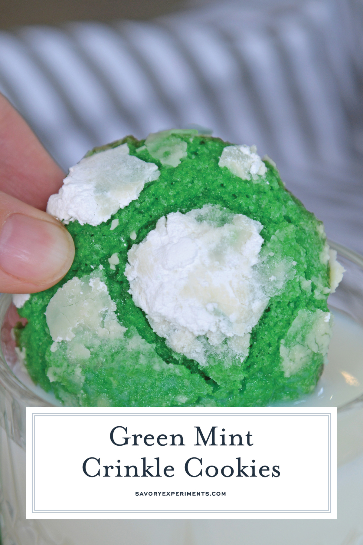 straight on shot of green mint crinkle cookie dipped into milk with text overlay