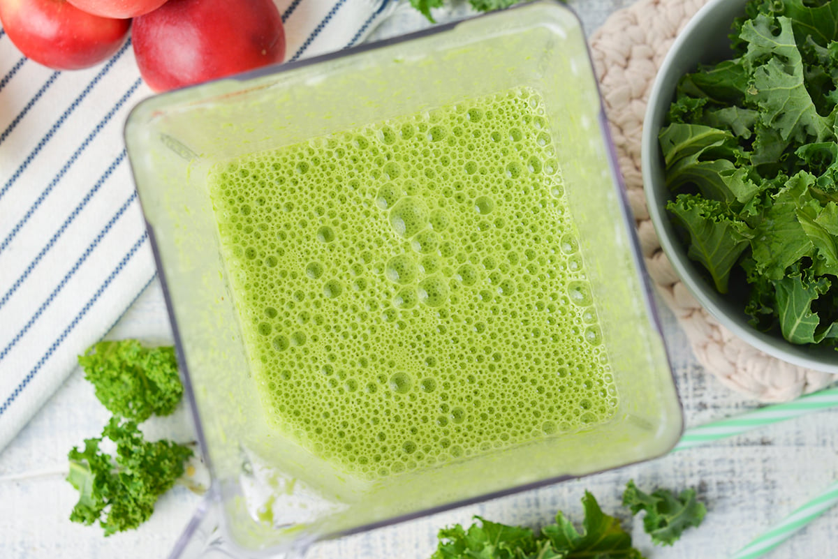 close up overhead shot of green smoothie in blender