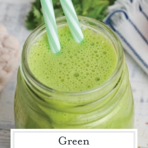 angled shot of green smoothie with two straws