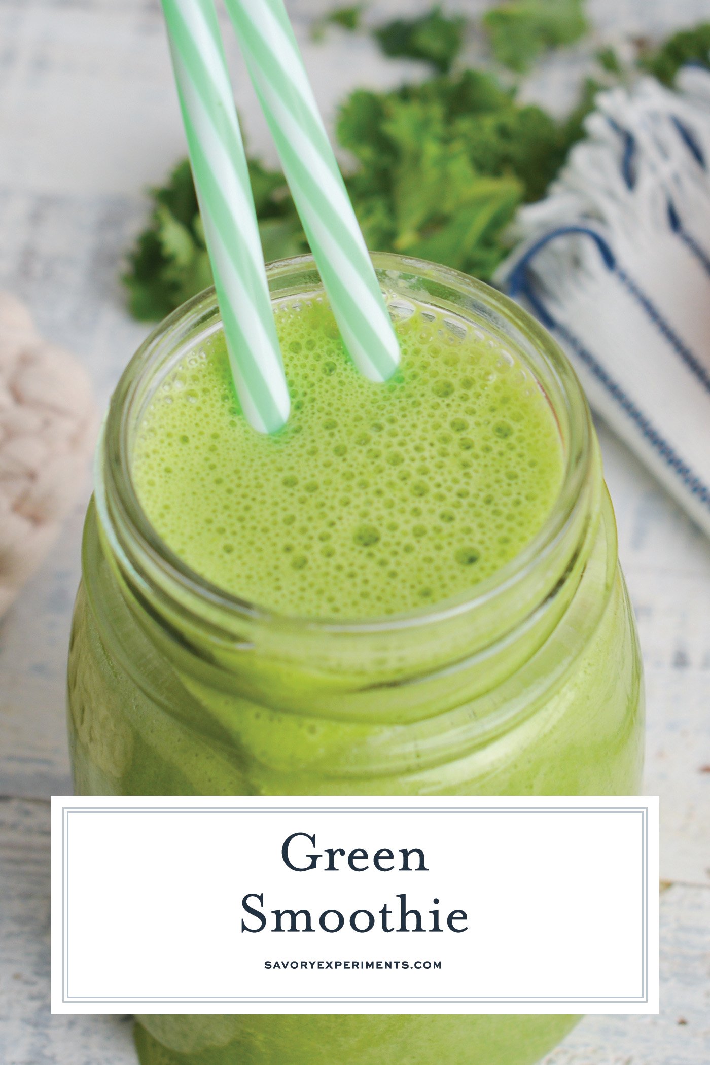 angled shot of green smoothie with two straws
