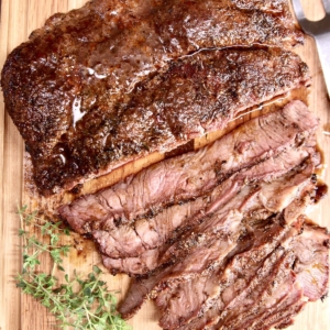 overhead shot of sliced grilled chuck roast on cutting board