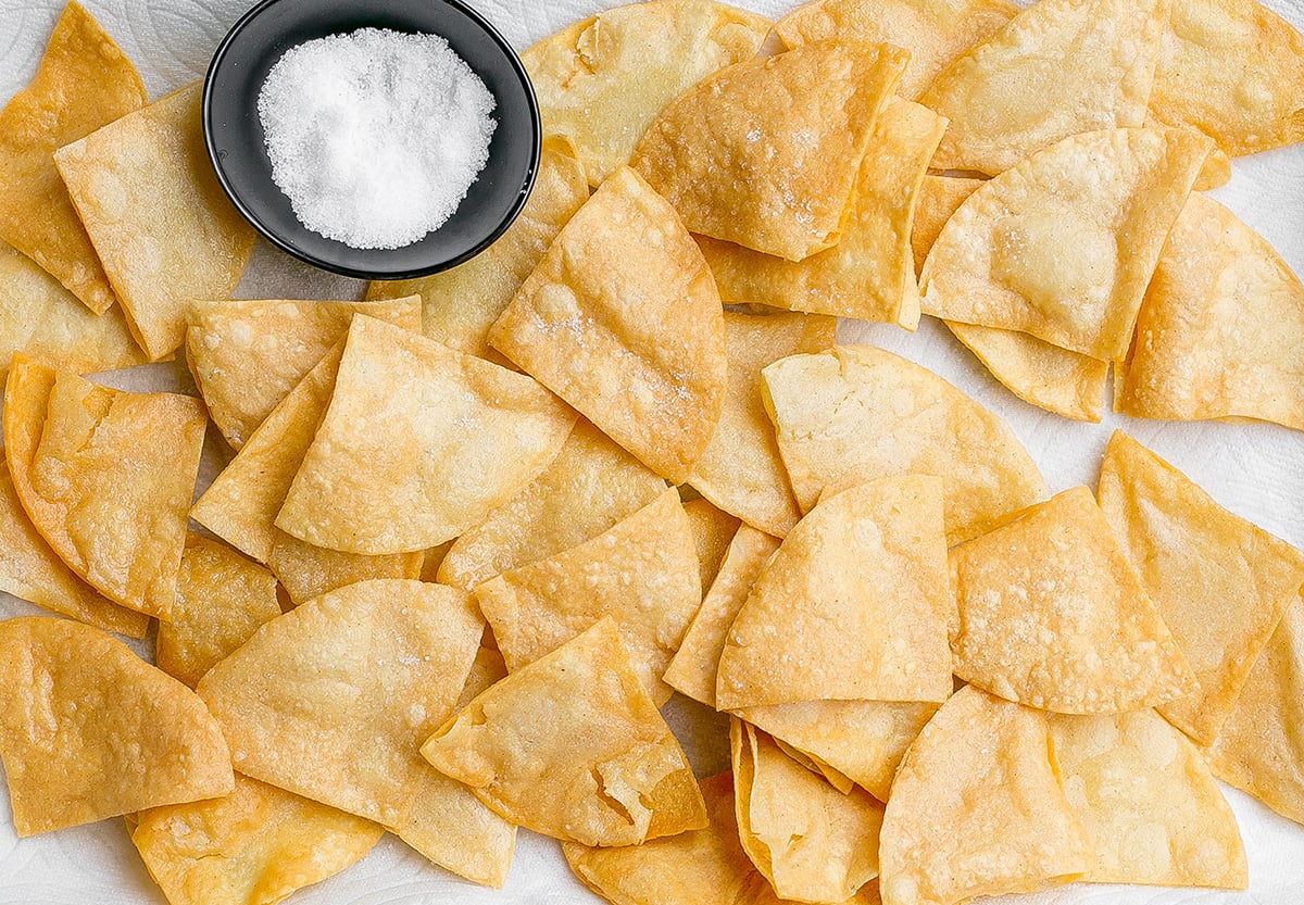 overhead shot of tortilla chips with bowl of sea salt
