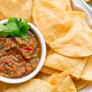 close up overhead shot of bowl of tortilla chips with bowl of salsa