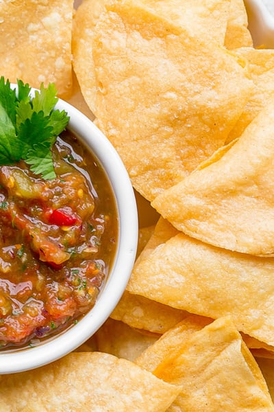 close up overhead shot of bowl of tortilla chips with bowl of salsa