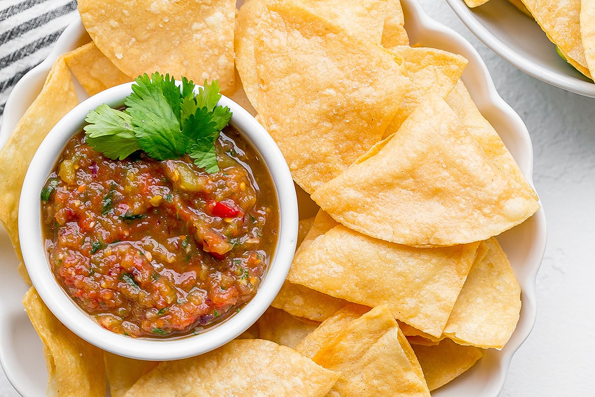 close up overhead shot of bowl of tortilla chips with bowl of salsa